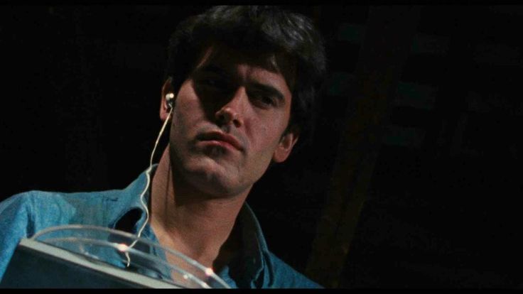 An screenshot of the movie Evil Dead, as Ash Williams listens to wired earbuds